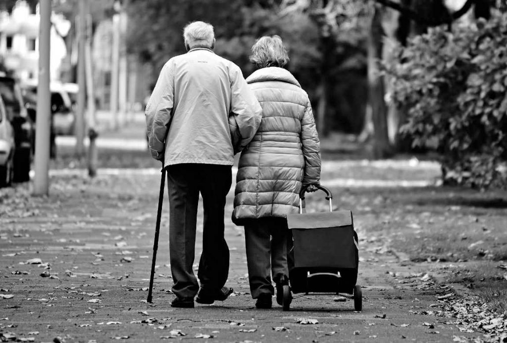 Old married couple walking arm and arm